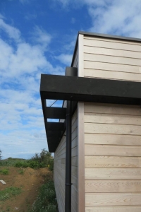Maison bois Finistère bandeau en Noir de Falun dissimule les coffres de volets roulants